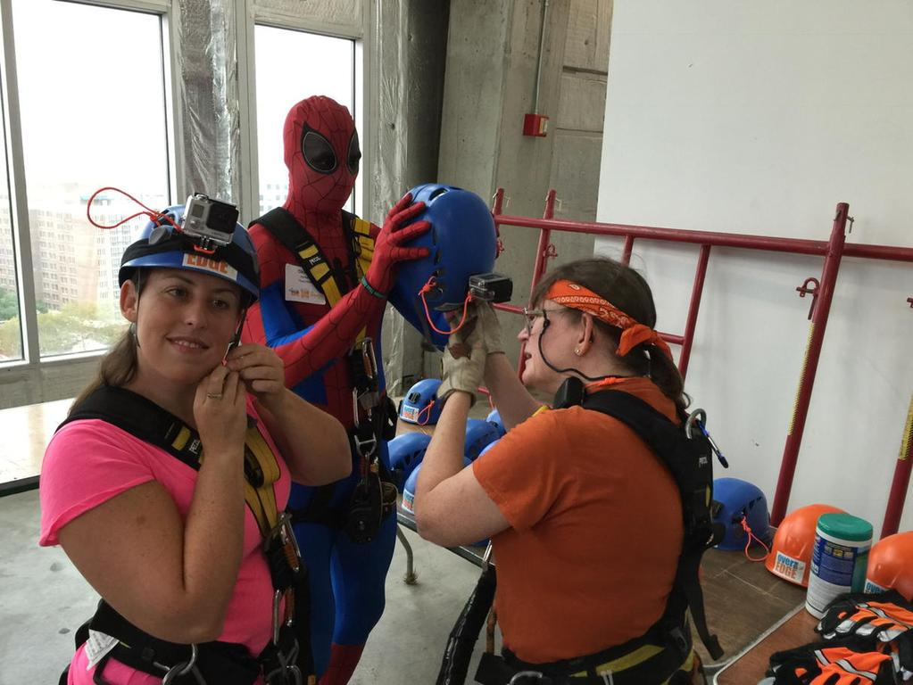 Victoria, on right with WTOP's Samantha Loss and Spider-Man, has been doing Over the Edge events since 2011. (WTOP/Kristi King)