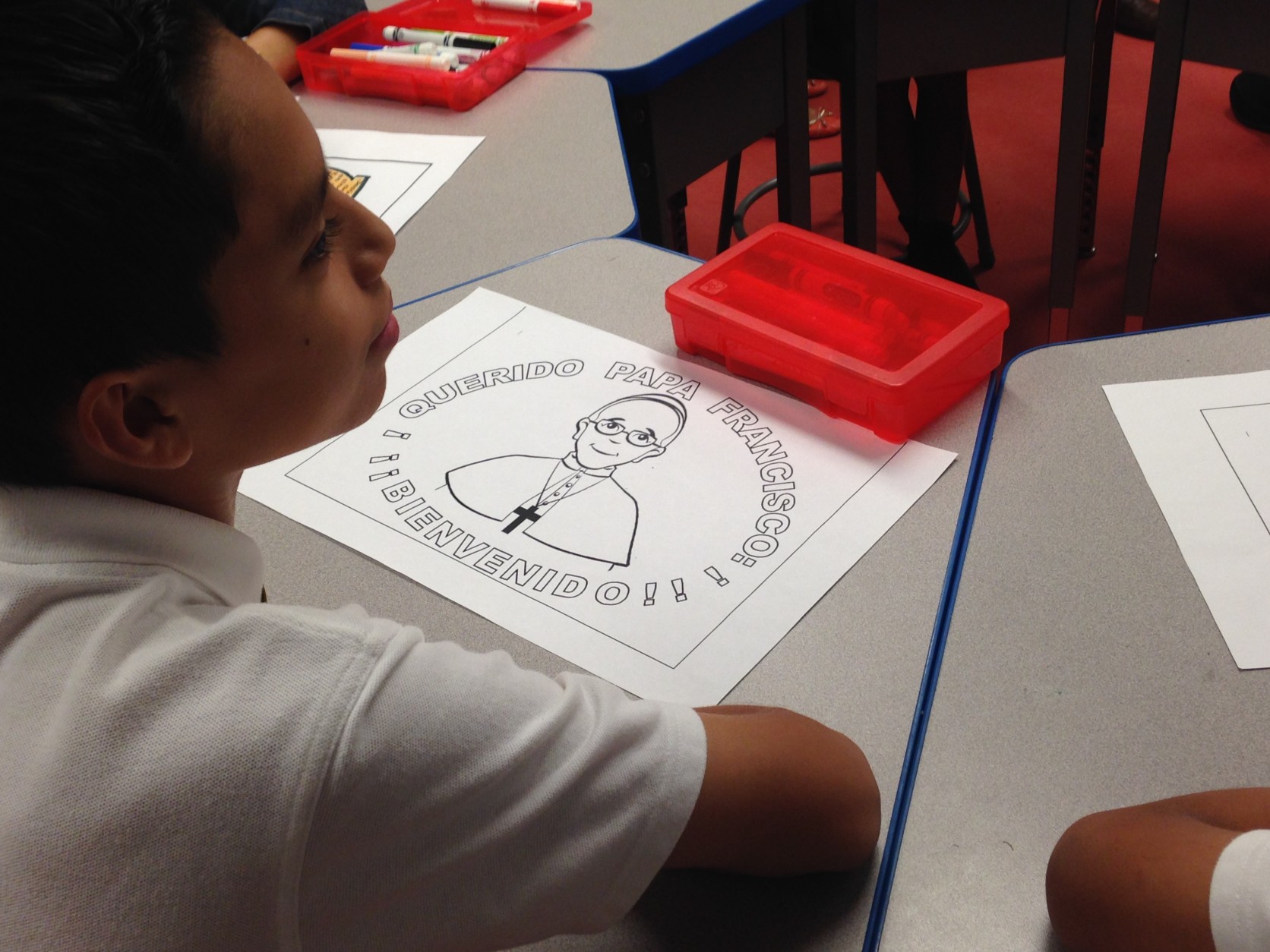 Children color pictures of Pope Francis. (WTOP/Jamie Forzato)