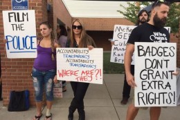 Demonstrators outside a Fairfax County Ad Hoc Police Practices Review Commission public hearing on Sept. 14, 2015. (WTOP/Michelle Basch)