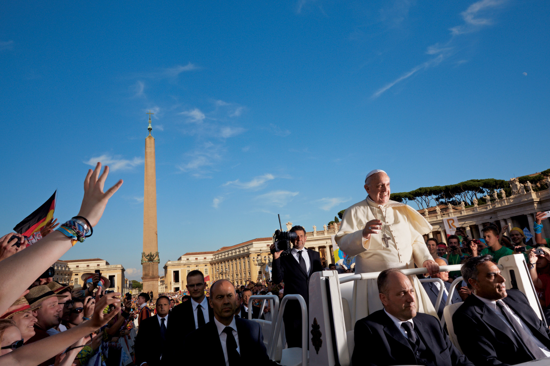 The open-topped Popemobile carries Pope Francis through a delighted crowd during a Wednesday general audience in St. Peter’s Square. (Dave Yoder/National Geographic)