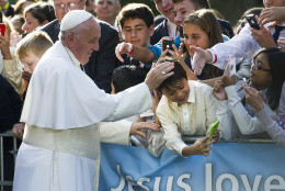 Pope Francis places his hand atop a young boys head while the boy takes a selfie before the Pope departs the Apostolic Nunciature, the Vatican's diplomatic mission in the heart of Washington, en route to the Capitol to address a joint meeting of Congress Thursday, Sept. 24, 2015.  (AP Photo/Cliff Owen)