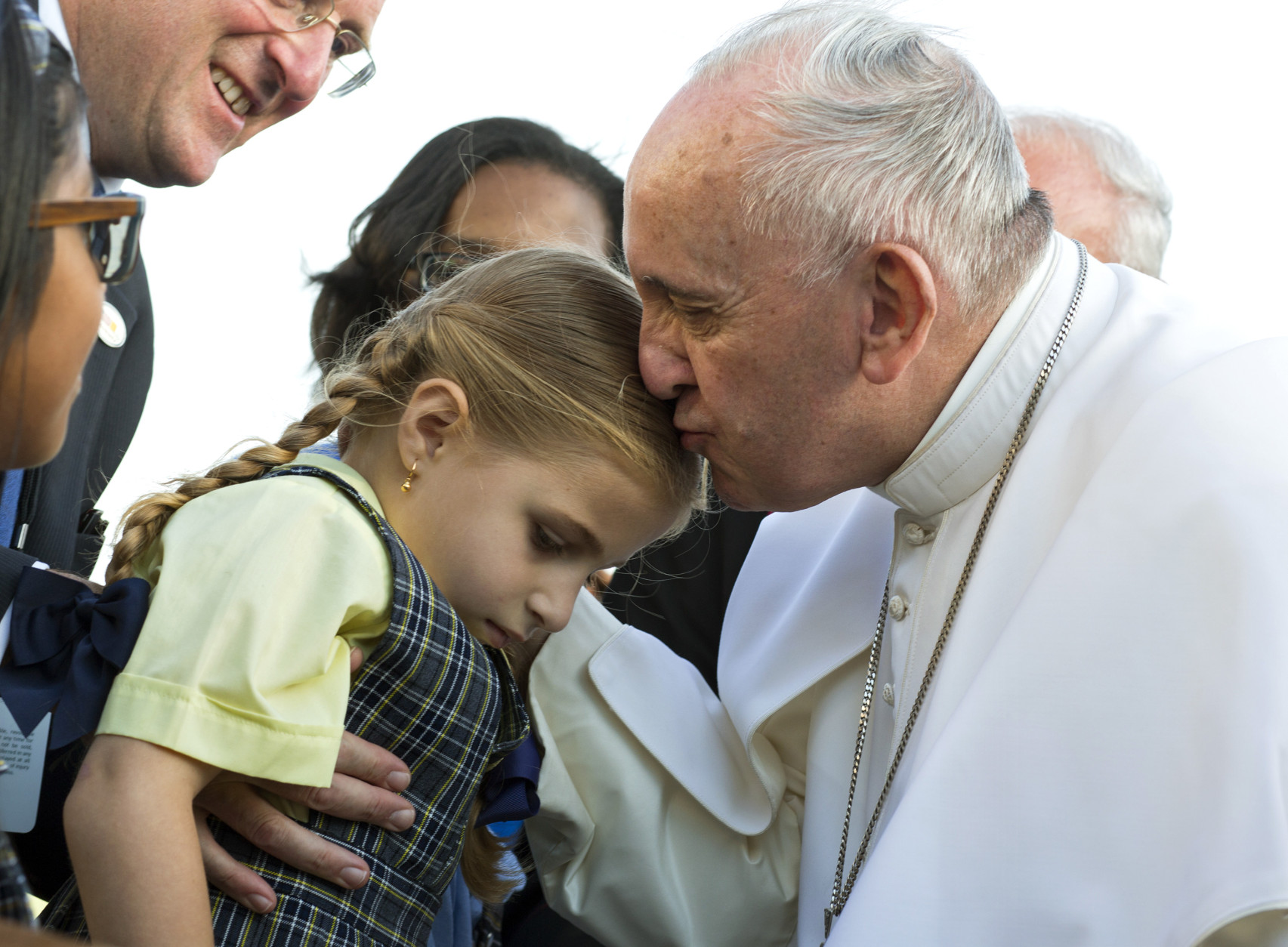 Pope Francis kisses Maria Teresa Heyer, a 1st grade student from the Brooklyn borough of New York, as the pope is greeted by Heyer and other students who gave him gifts as he arrives at John F. Kennedy International Airport Thursday, Sept. 24, 2015, in New York.  (AP Photo/Craig Ruttle, Pool)