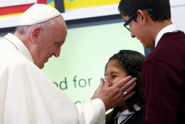 Pope Francis touches a student's face as he visits Our Lady Queen of Angels School in East Harlem, New York, Friday, Sept.  25, 2015.  (Tony Gentile/ Pool Photo via AP)