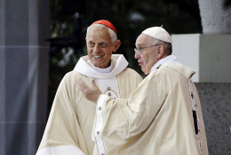 Cardinal Donald Wuerl, archbishop of Washington. left, looks toward the crowd with Pope Francis following a Mass outside the Basilica of the National Shrine of the Immaculate Conception Wednesday, Sept. 23, 2015, in Washington. (AP Photo/David Goldman)