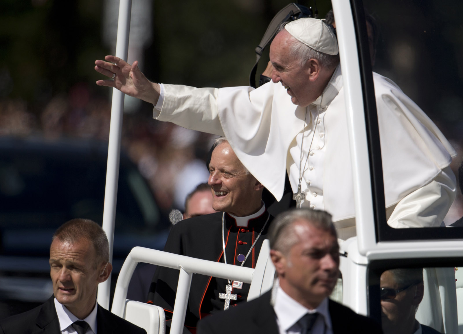 Pope Francis, joined by Cardinal Donald Wuerl, archbishop of Washington, waves from his popemobile during a parade around the Ellipse near the White House in Washington, Wednesday, Sept. 23, 2015. (AP Photo/Carolyn Kaster)