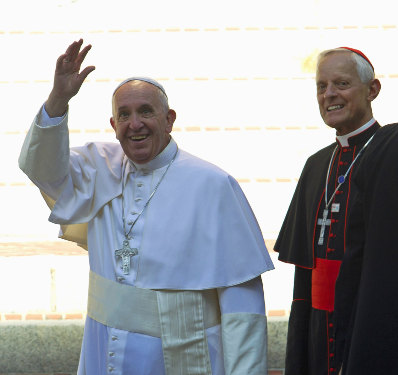 Pope Francis, accompanied by Cardinal Donald Wuerl, archbishop of Washington, waves to the crowd as they arrive  at St. Mathews Cathedral in Washington, Wednesday, Sept. 23, 2015. ( AP Photo/Jose Luis Magana)