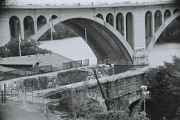 The Aqueduct Bridge carried canalboats, horse-drawn wagons, and eventually trolley cars and automobiles across the Potomac River for nearly a century. It was demolished in 1933 but a remnant abutment still towers over the Capital Crescent Trail in Georgetown today. In the shadow of the Key Bridge, the stonework above the two surviving arches is mottled by graffiti. (WTOP/Dave Dildine)