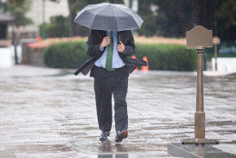 UNITED STATES - October 1: A man walks through the rain near the U.S. Capitol in Washington, on Thursday, Oct. 1, 2015. (Photo By Al Drago/CQ Roll Call)