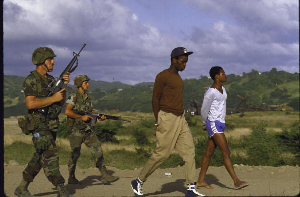 American soldiers guarding suspected members of the People's Revolutionary Army of Grenada during the US OP Urgent Fury invasion of the island feared a Cuban/Soviet military threat in the Caribbean after a Marxist coup.  (Photo by Matthew Naythons/The LIFE Images Collection/Getty Images)