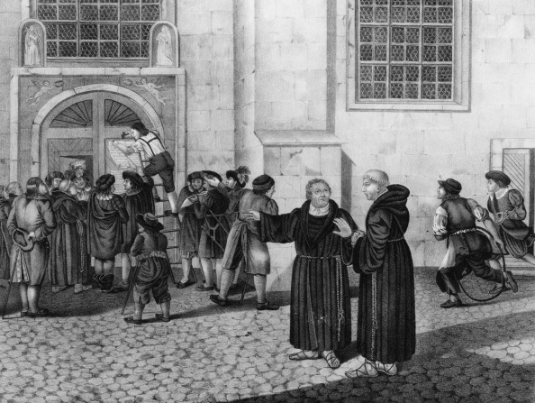 Illustration of a small crowd has gathered to watch as Martin Luther directs the posting of his 95 theses, protesting the practice of the sale of indulgences, to the door of the castle church in Wittenberg. Dated 1517. Photo by: (Universal History Archive/UIG via Getty images)