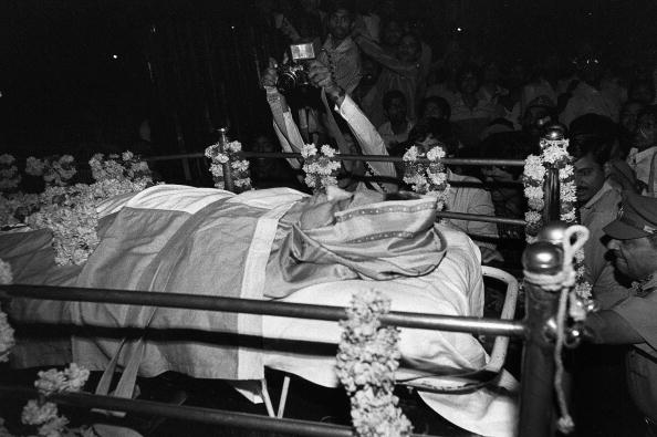 DELHI, INDIA:  (FILES) In this picture taken 31 October 1984, slain Indian Prime Minister Indira Gandhi lies in state on a gun carriage wrapped in an Indian flag at the hospital where she died after having been shot in front of her residence in New Delhi.  31 October 2004, will mark the 20th anniversary of Mrs Gandhi's assasination by her Sikh bodyguards, four months after she ordered troops into the Golden Temple in Amritsar to flush out Sikh militants fighting for an independent state. Twenty years after the assassination of Indira Gandhi, India is remembering with strong emotions the woman who holds the record as the longest serving prime minister of the world's largest democracy.    AFP PHOTO/BEDI  (Photo credit should read BEDI/AFP/Getty Images)