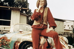 American singer-songwriter Janis Joplin (1943 - 1970) with her 1965 Porsche 356C Cabriolet, circa 1969. The car features a psychedelic paint job by Joplin's roadie, Dave Richards. (Photo by RB/Redferns)