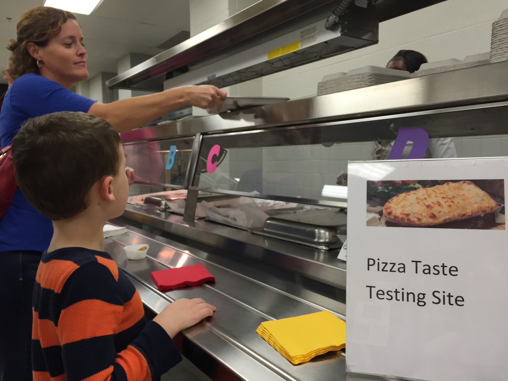 Moms, dads and kids also got to try four different kinds of pizza and were asked to vote for their favorite. The winner will be served in every Arlington school through the end of the school year. (WTOP/Michelle Basch)