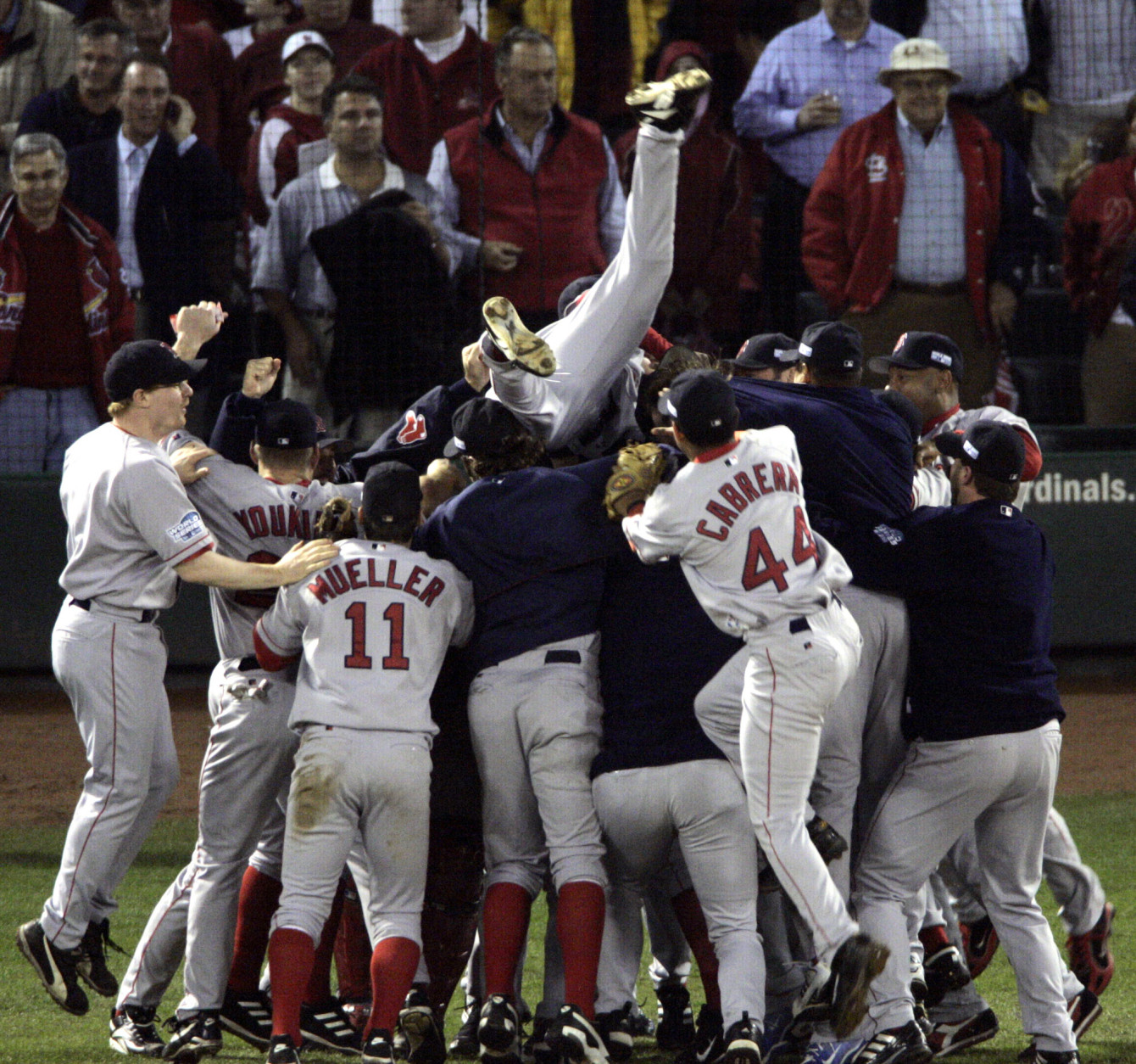 Boston Red Sox players celebrate after beating the St. Louis Cardinals 3-0 in Game 4 to sweep the World Series Wednesday, Oct. 27, 2004, in St. Louis. (AP Photo/Sue Ogrocki)