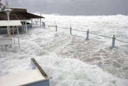Waves reach The Wharf patio restaurant, damaging the bar and main deck, in George Town, Grand Cayman Island, Thursday, Oct. 20, 2005. Hurricane Wilma moved away from the Cayman Islands but residents and tourists are still feeling rough seas and battering waves on the south and west coasts. (AP Photo/Caymanian Compass, Justin Uzzell)