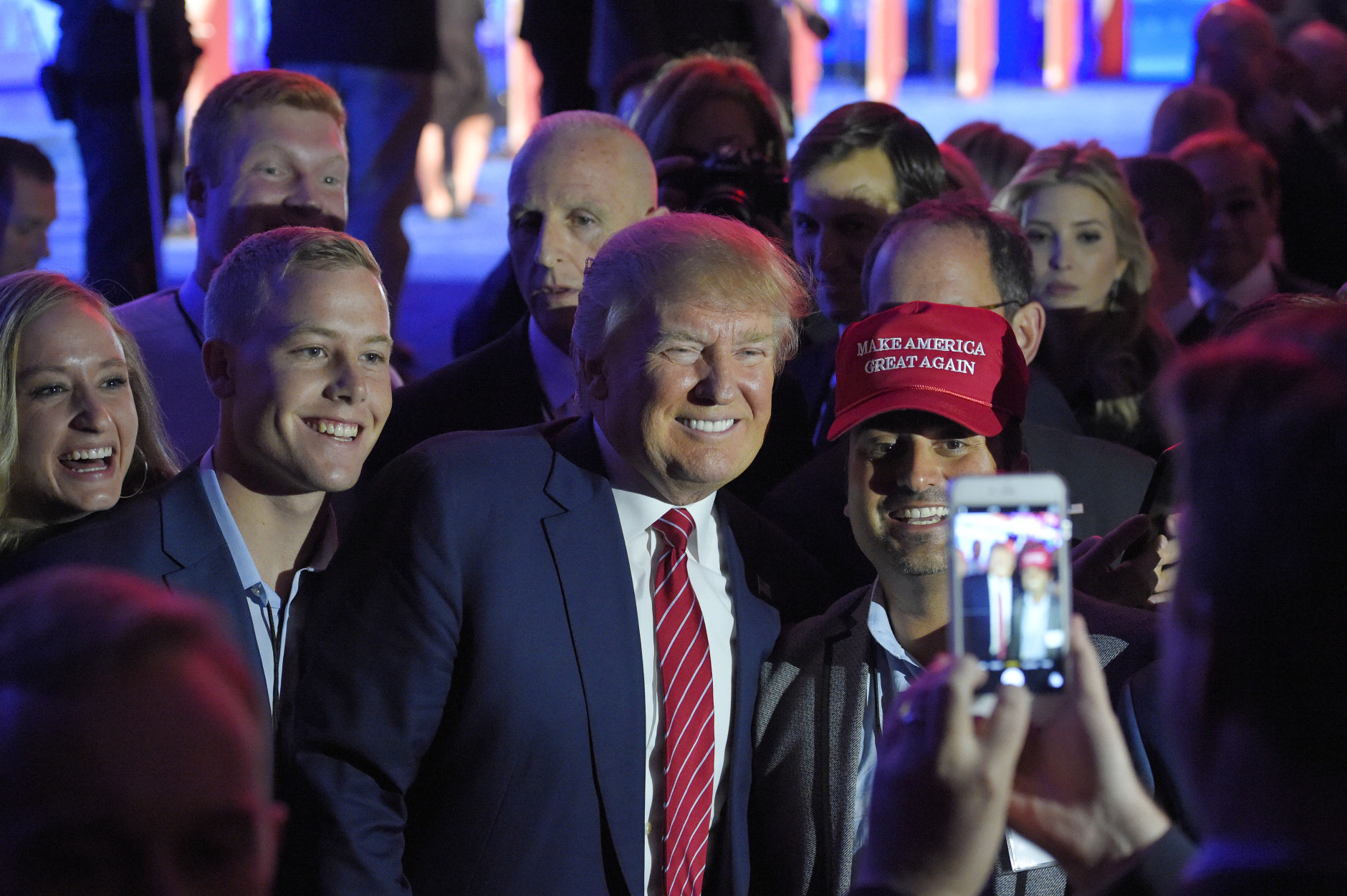 Donald Trump, center, poses for a photo with Denver attorney Gabriel Schwartz (with hat) and others following the CNBC Republican presidential debate at the University of Colorado, Wednesday, Oct. 28, 2015, in Boulder, Colo. (AP Photo/Mark J. Terrill)