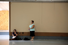 Friends and family wait for students at the local fairgrounds after a deadly shooting at Umpqua Community College, in Roseburg, Ore., Thursday, Oct. 1, 2015. (AP Photo/Ryan Kang)