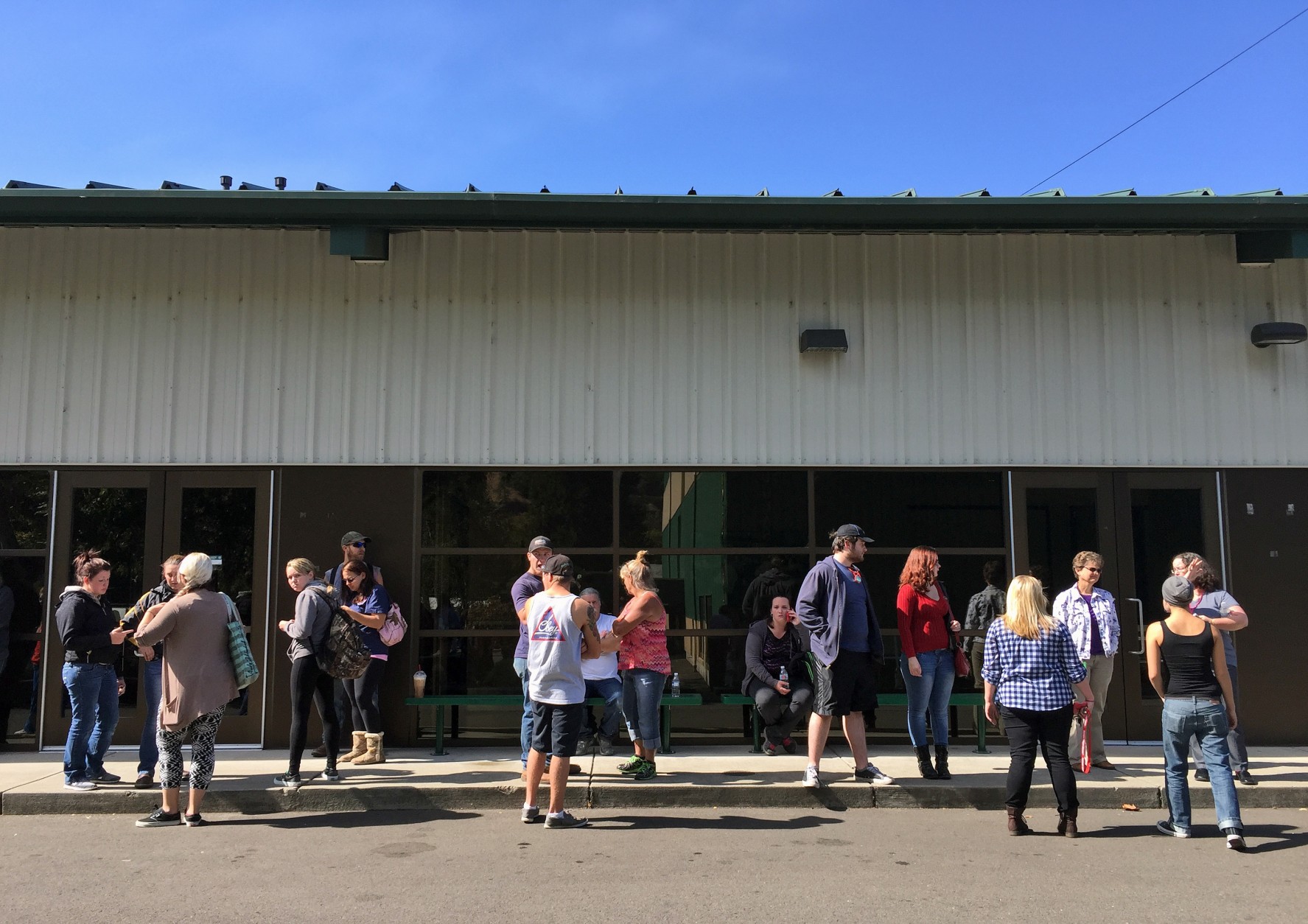 People wait for information at the local fairgrounds after a deadly shooting at Umpqua Community College, in Roseburg, Ore., Thursday, Oct. 1, 2015.  (AP Photo/Ryan Kang)