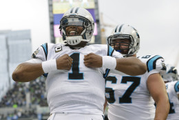 Carolina Panthers quarterback Cam Newton reacts after he rushed for a touchdown in the first half of an NFL football game against the Seattle Seahawks, Sunday, Oct. 18, 2015, in Seattle. (AP Photo/Elaine Thompson)