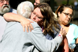 Friends and family are reunited with students at the local fairgrounds after a deadly shooting at Umpqua Community College, in Roseburg, Ore., Thursday, Oct. 1, 2015. (AP Photo/Ryan Kang)