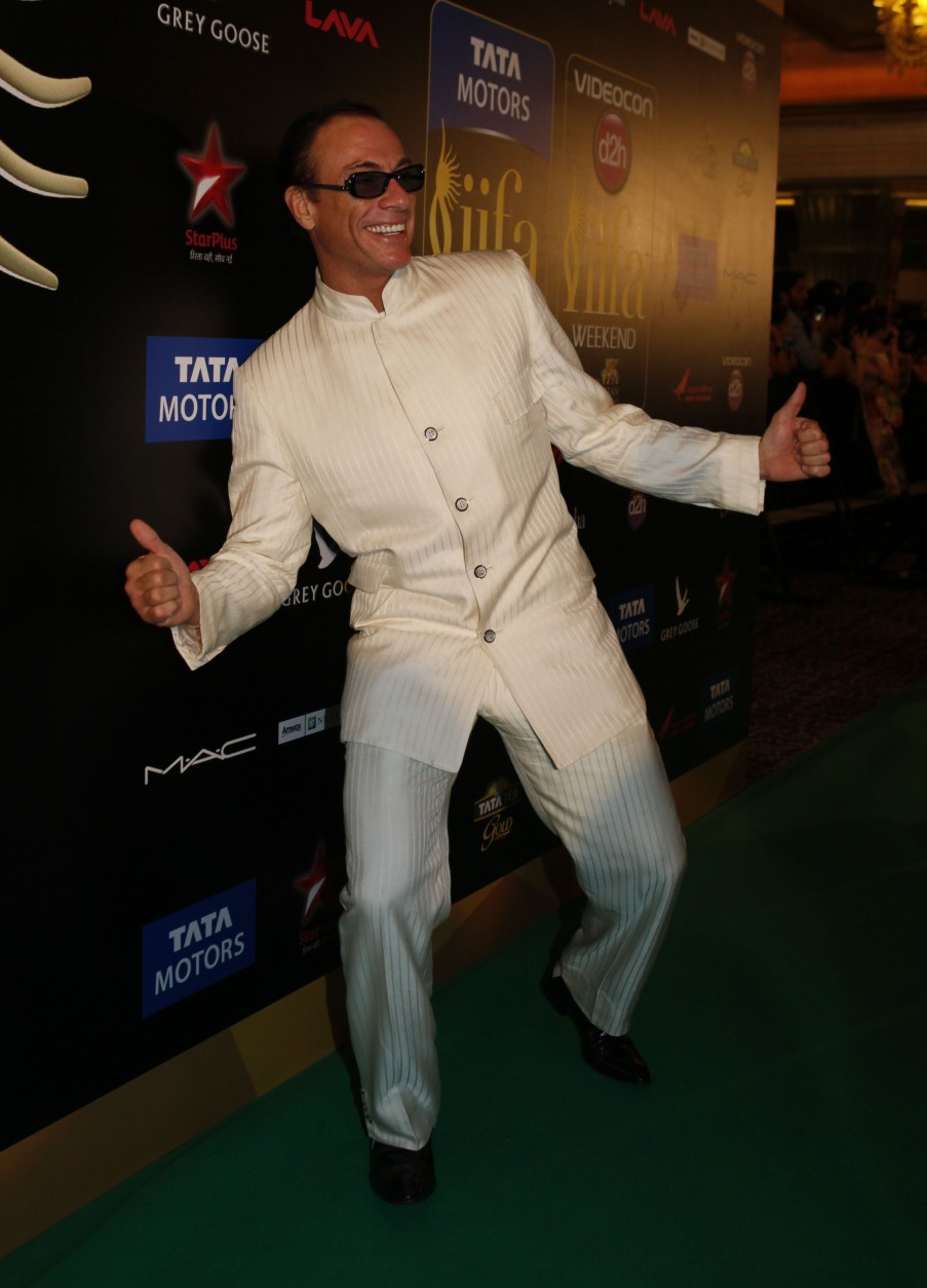 Hollywood actor Jean-Claude Van Damme arrives for the International Indian Film Academy (IIFA) awards in Macau, Saturday, July 6, 2013. (AP Photo/Kin Cheung)