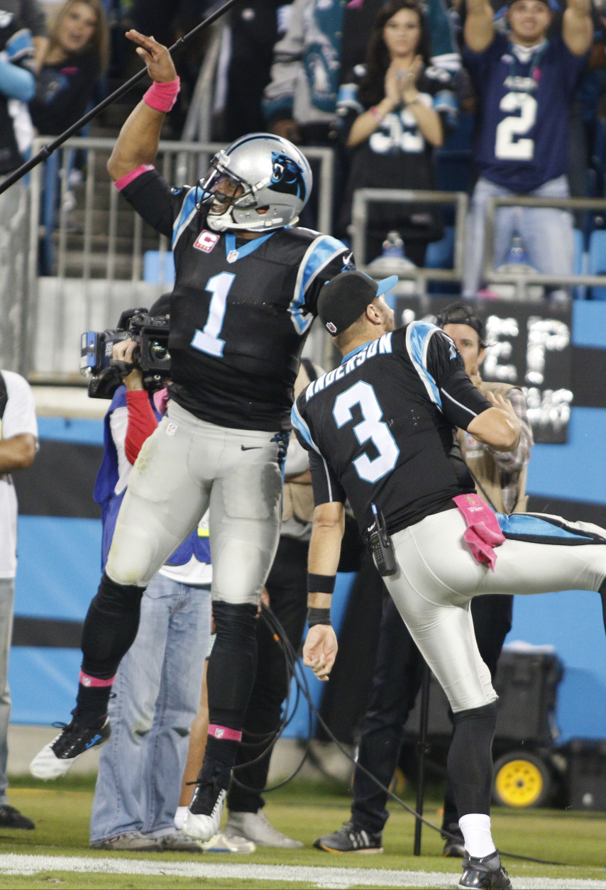 Carolina Panthers' Cam Newton (1) and Derek Anderson (3) celebrate a touchdown against the Philadelphia Eagles in the second half of an NFL football game in Charlotte, N.C., Sunday, Oct. 25, 2015. (AP Photo/Bob Leverone)