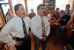 FILE - In this Oct. 3, 1995 file photo, Justin Barker, left, and his colleague Juan Borrego react as they hear the verdict of the O.J. Simpson trial from a Hooters restaurant in Miami. Barker was jubilant while Borrego had believed he was guilty beyond reasonable doubt. Simpson was acquitted for the June 1994 murders of his ex-wife and her friend. (AP Photo/Marta Lavandier)