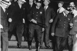 Chicago crime boss Al Capone, left, wearing white hat, is in the custody of U.S. marshals as he leaves the courtroom in Chicago on October 12, 1931. Capone was convicted on tax evasion charges. (AP Photo)