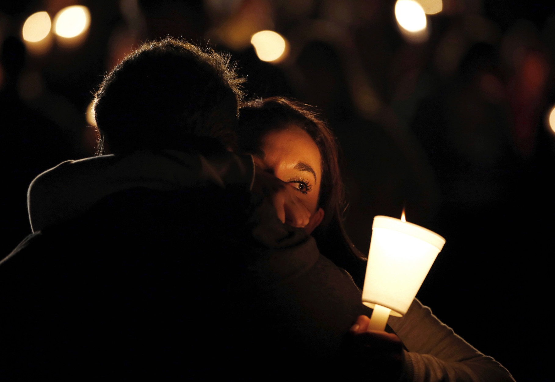 Umpqua Community College student Nichole Zamarripa, right, is consoled during a candle light vigil for those killed during a fatal shooting at the school, Thursday, Oct. 1, 2015, in Roseburg, Ore. (AP Photo/Rich Pedroncelli)