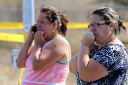 Two woman wait outside Umpqua Community College campus after a shooting at the school in Roseburg, Ore., on Thursday, Oct. 1, 2015.   (AP Photo/Ryan Kang)