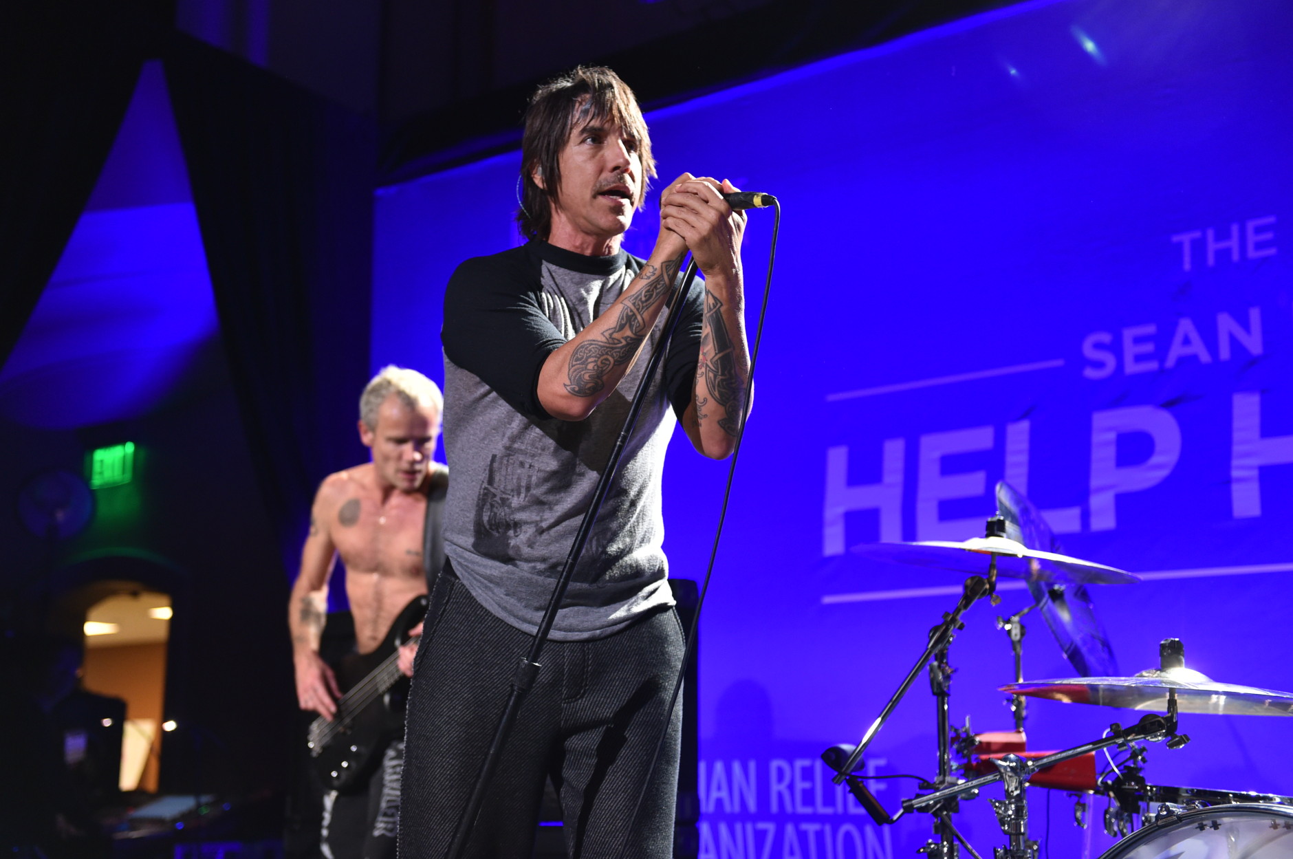 Michael "Flea" Balzary, left, and Anthony Kiedis of the Red Hot Chili Peppers perform on stage at Sean Penn And Friends "Help Haiti Home" Gala - Show at the Montage Hotel on Saturday, Jan. 10, 2015 in Beverly Hills, Calif.  (Photo by John Shearer/Invision/AP)