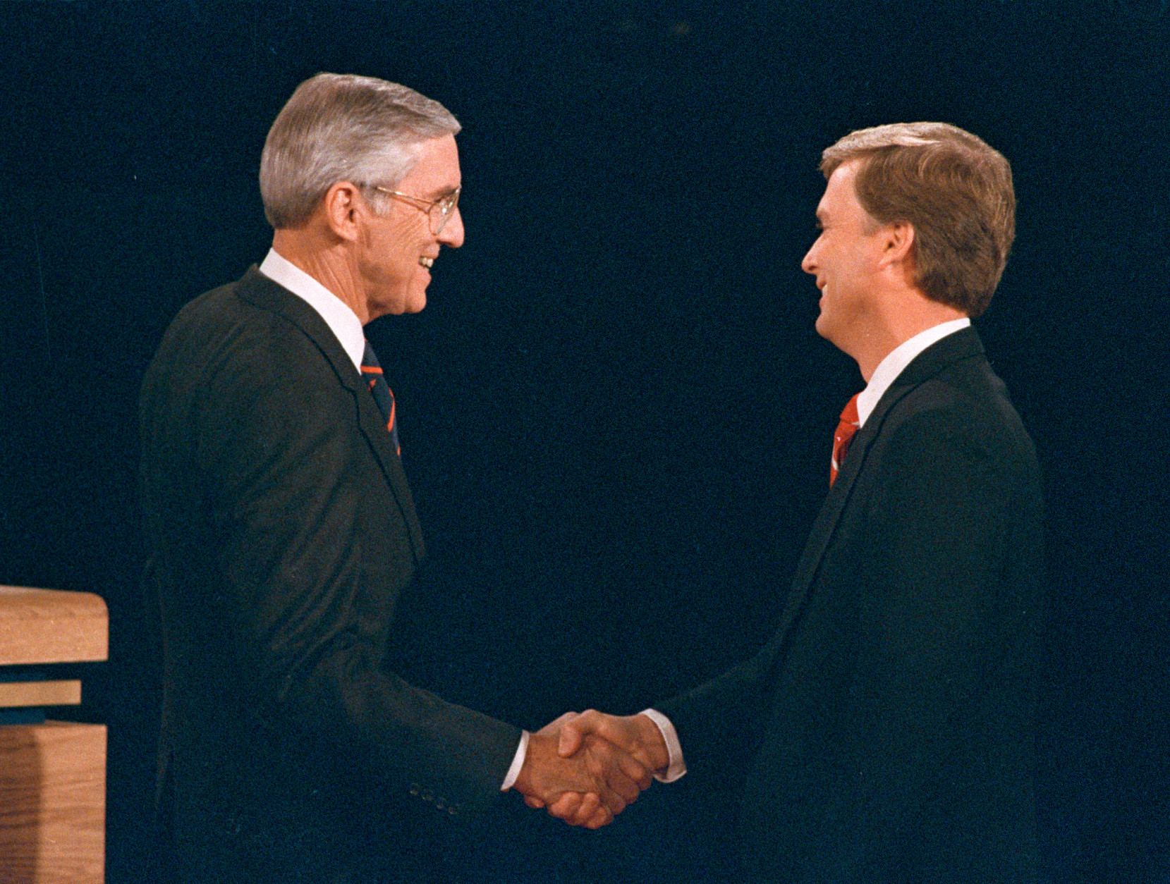 FILE - In this Oct. 5, 1988, file photo, Sen. Lloyd Bentsen, D-Texas, left, shakes hands with Sen. Dan Quayle, R-Ind., before the start of their vice presidential debate at the Omaha Civic Auditorium, Omaha, Neb. They spend hours mastering policy. Learning to lean on the podium just so. Perfecting the best way to label their opponents as liars without whining. But presidential candidates and their running mates often find that campaign debates turn on unplanned zingers, gaffes or gestures that speak volumes. Debate wins and losses often are scored based on the overall impressions that candidates leave with voters. In the history books, though, small debate moments often end up telling the broader story. (AP Photo/Ron Edmonds)