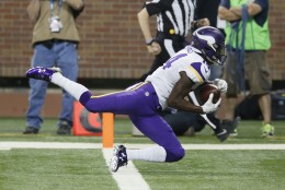 Minnesota Vikings wide receiver Stefon Diggs (14) falls into the end zone after a 36-yard reception for a touchdown during the second half of an NFL football game against the Detroit Lions, Sunday, Oct. 25, 2015, in Detroit. (AP Photo/Duane Burleson)