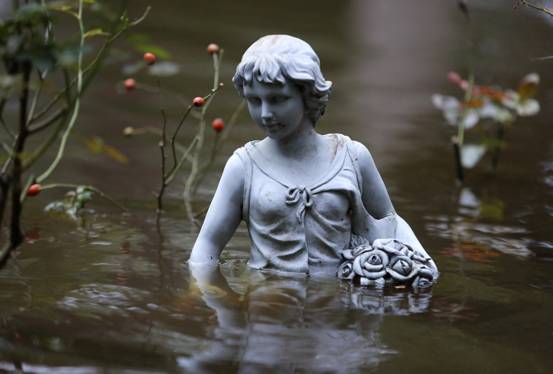 A statue in flood waters in the Ashborough subdivision near Summerville, S.C., Monday, Oct. 5, 2015. South Carolina is still struggling with flood waters due to a slow moving storm system. (AP Photo/Mic Smith)