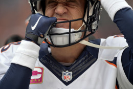 Denver Broncos quarterback Peyton Manning adjusts his helmet before an NFL football game against the Cleveland Browns, Sunday, Oct. 18, 2015, in Cleveland. (AP Photo/David Richard)