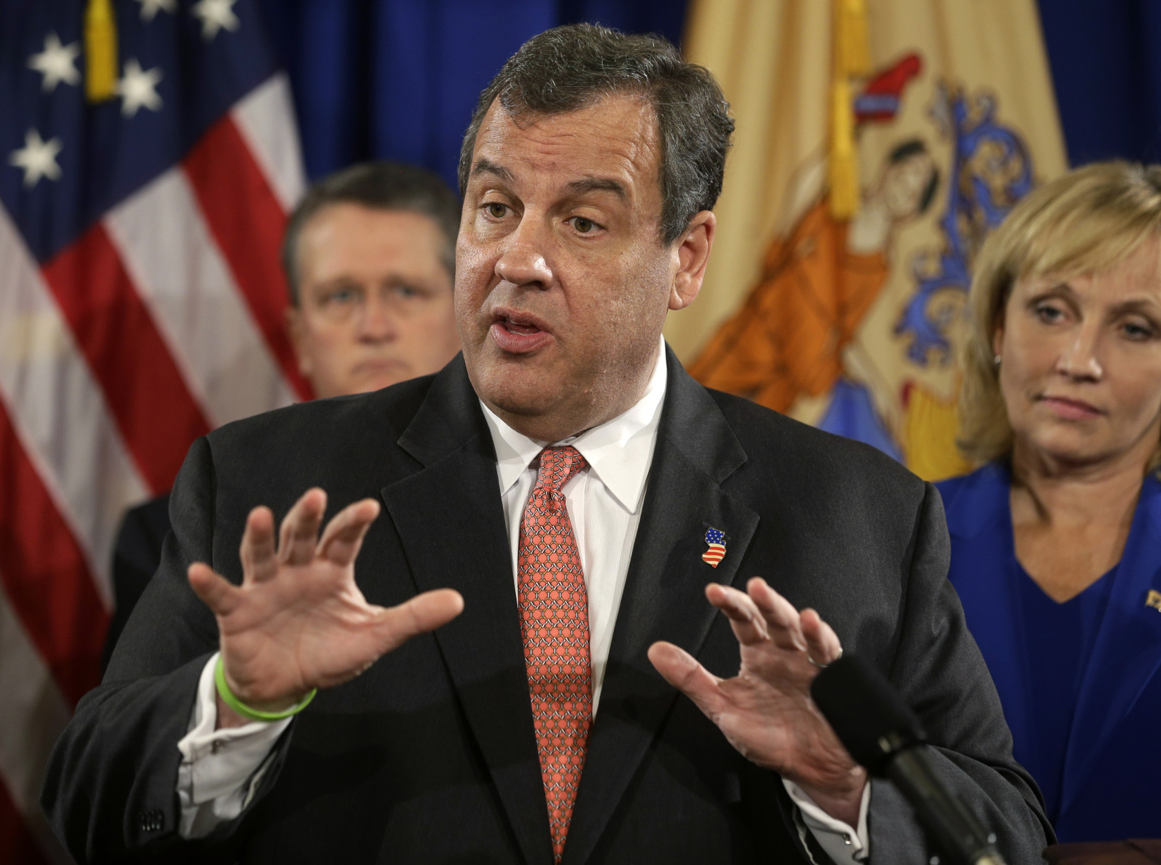 New Jersey Gov. Chris Christie addresses a gathering to lay out preparation plans for a possible weekend rainstorm Thursday, Oct. 1, 2015, in Trenton, N.J.  Governors up and down the East Coast are warning residents to prepare for drenching storms as flooding killed one person Thursday in South Carolina. The rains could cause power outages and close roads in a region already walloped by rain. Hurricane Joaquin's approach could intensify the damage, but rain is forecast across the region regardless of the storm's path. Listening in the background are John Hoffman, left, acting Attorney General of the State of New Jersey, and Lt. Gov. Kim Guadagno. (AP Photo/Mel Evans)