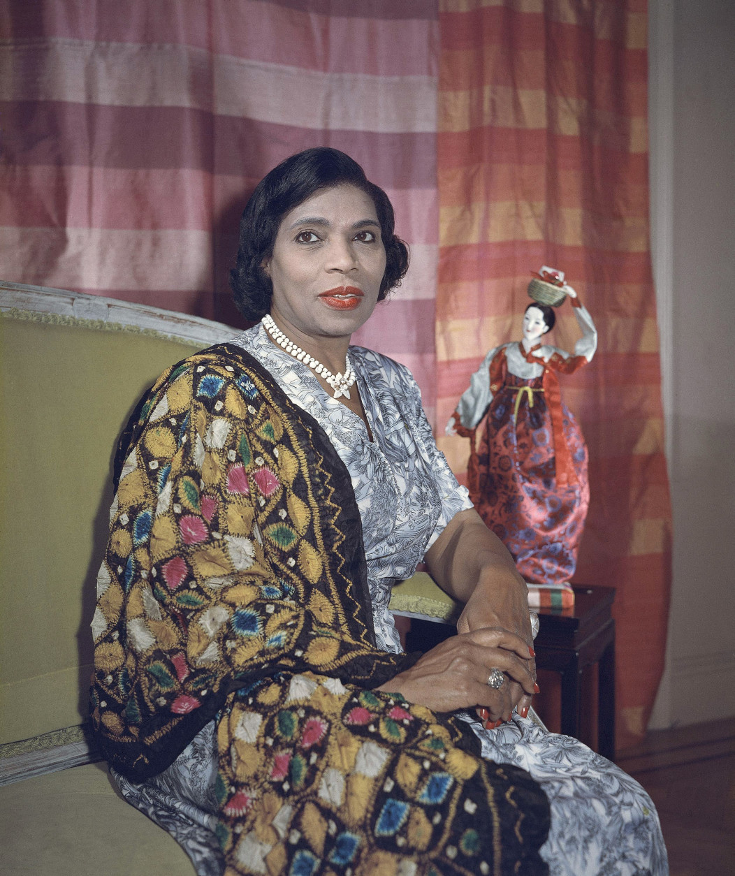Singer Marian Anderson holds a Korean doll in her New York apartment, Aug. 5, 1958. The doll and the shawl she is wearing are gifts received on a trip to the Far East. Miss Anderson became a member of the United States delegation to the United Nations, which she sees as an opportunity to contribute to the mutual understandings of people. (AP Photo)