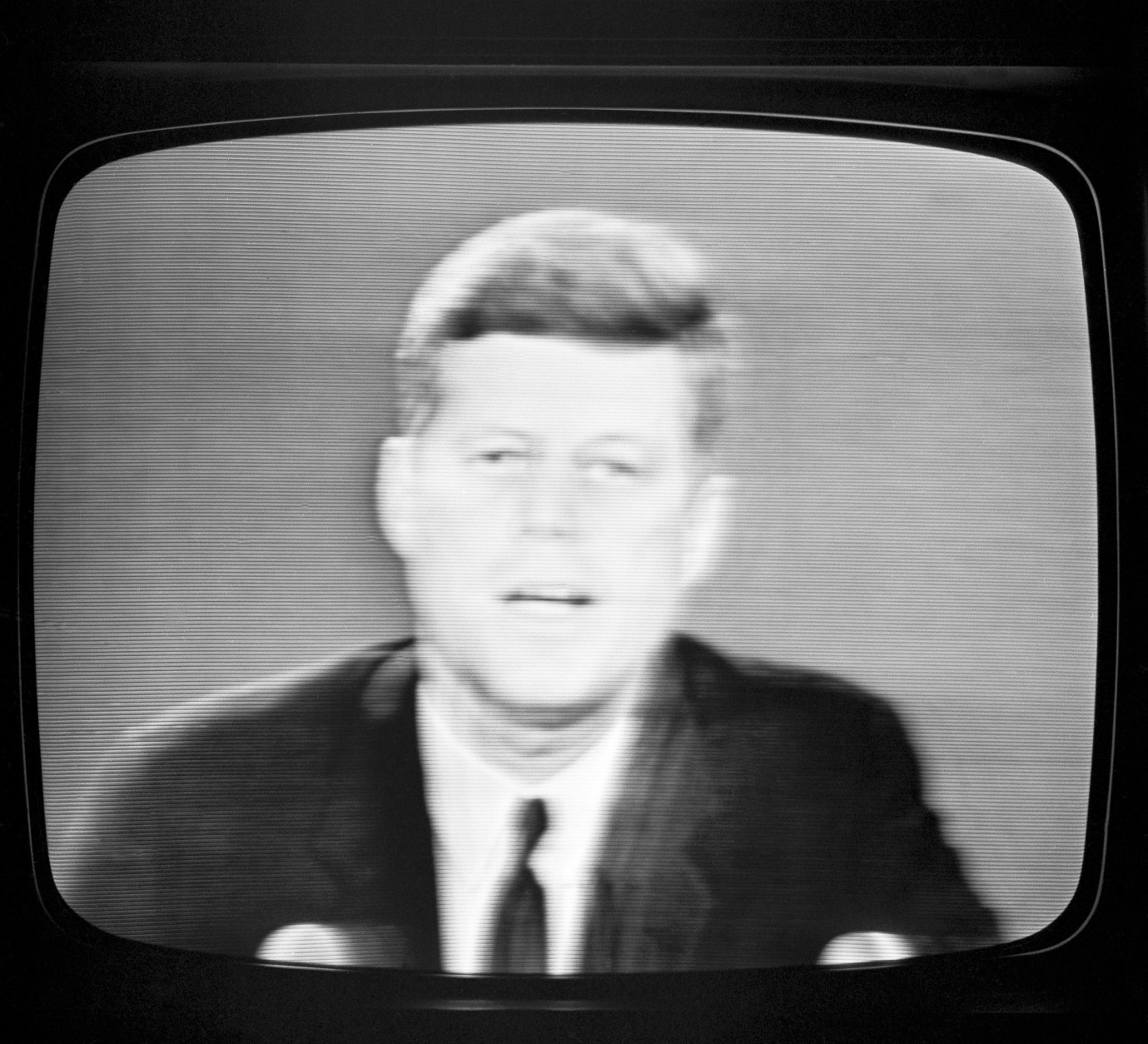 President John F. Kennedy as he appeared on a television set in New York City  Oct. 22, 1962 informing the American people of his decision to set up a naval blockade against Cuba. (AP Photo)