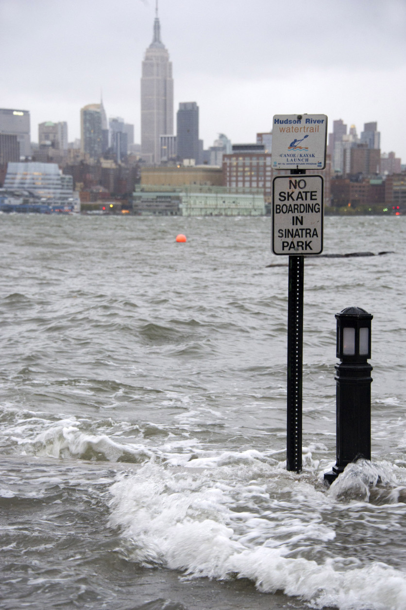 The Hudson River swells and rises over the banks of the Hoboken, N.J. waterfront as Hurricane Sandy approaches on Monday, Oct. 29, 2012. (AP Photo/Charles Sykes)