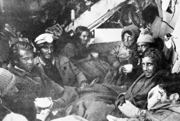 The last eight survivors of the Uruguayan Air Force plane crash in the Andes in South America, huddle together in the craft's fuselage on their final night before rescue on Dec. 27, 1972. A mountain rescue team brought them food. (AP Photo)