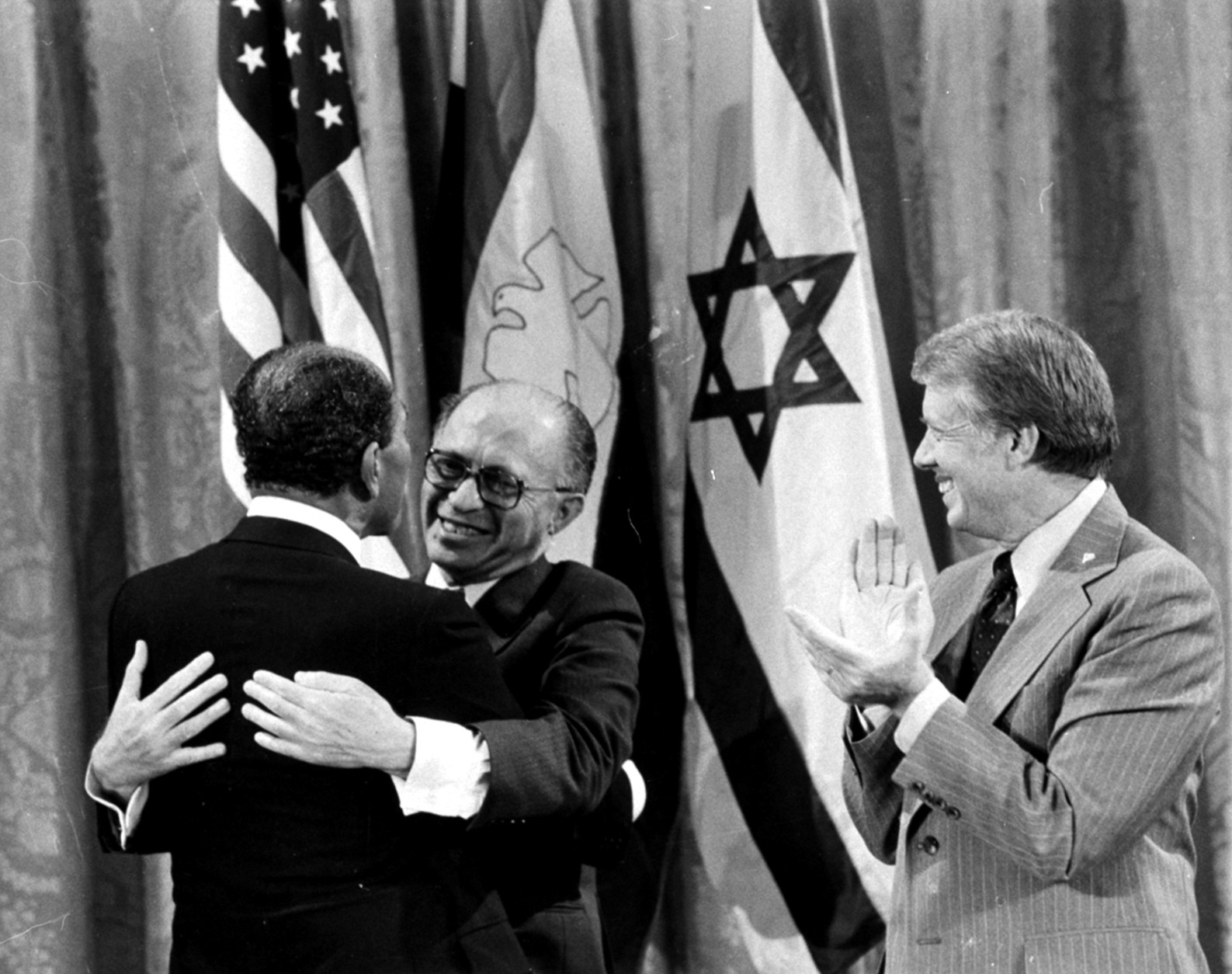 Egyptian President Anwar Sadat, left, and Israeli Prime Minister Menachem Begin, embrace as U.S. President Jimmy Carter looks on, September 18, 1978, during a White House announcement of a Middle East peace agreement reached at the Camp David Summit earlier this year.  Sadat and Begin were named joint winners in the 1978 Nobel Peace Prize in an announcement Friday, October 27, from officials in Oslo, Norway.  (AP Photo)