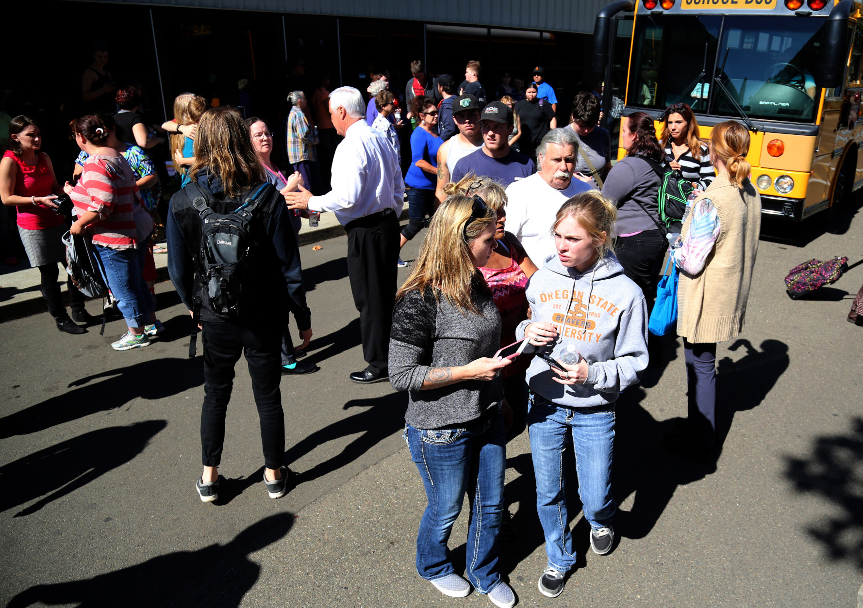Friends and family are reunited with students at the local fairgrounds after a mass shooting at Umpqua Community College, in Roseburg, Thursday, Oct. 1, 2015. Multiple people were killed after a gunman opened fire at the campus early Thursday. (AP Photo/Ryan Kang)