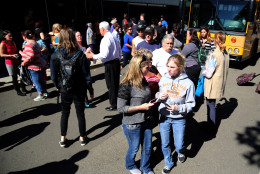 Friends and family are reunited with students at the local fairgrounds after a mass shooting at Umpqua Community College, in Roseburg, Thursday, Oct. 1, 2015. Multiple people were killed after a gunman opened fire at the campus early Thursday. (AP Photo/Ryan Kang)