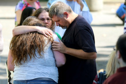 Friends and family are reunited with students at the local fairgrounds after a deadly shooting at Umpqua Community College, in Roseburg, Ore., Thursday, Oct. 1, 2015.  (AP Photo/Ryan Kang)