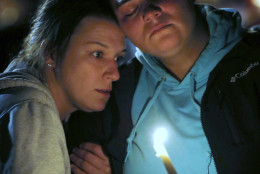 Angel Martinez, left, comforts Brenda Valenzuela during a candle light vigil for those killed during a fatal shooting at Umpqua Community College, Thursday, Oct. 1, 2015, in Roseburg, Ore. Valenzuela was on campus and saw the gunman. (AP Photo/Rich Pedroncelli)