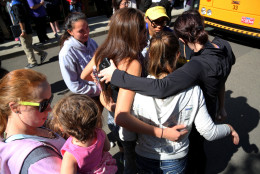 Friends and family are reunited with students at the local fairgrounds after a mass shooting at Umpqua Community College, in Roseburg, Thursday, Oct. 1, 2015. Multiple people were killed after a gunman opened fire at the campus early Thursday. (AP Photo/Ryan Kang)