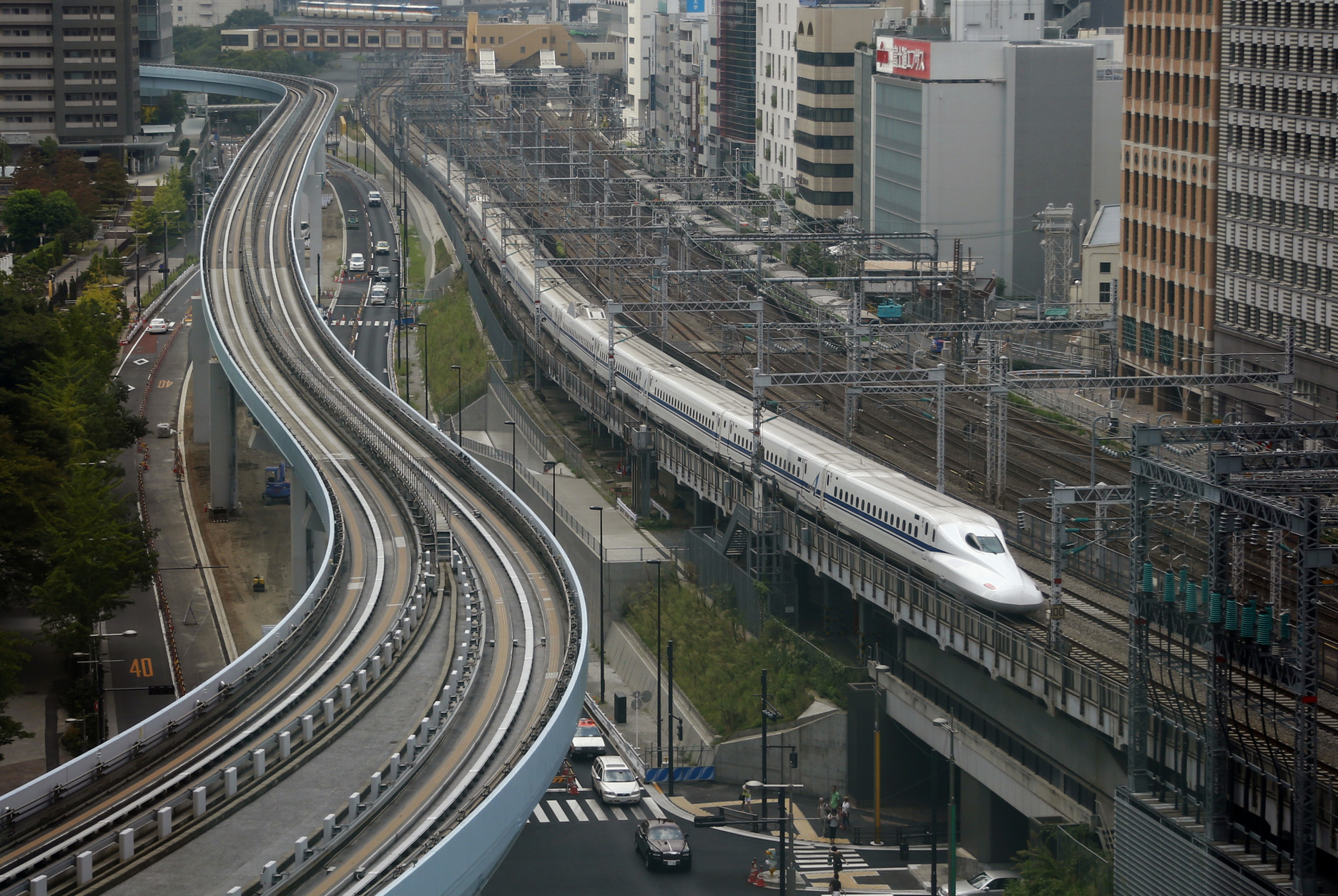 In this Sept. 24, 2014 photo, a Shinkansen bullet train heads for Tokyo Station on the Tokaido Main Line in Tokyo. Japan launched its bullet train between Tokyo and Osaka 50 years ago Wednesday, Oct. 1, 2014. (AP Photo/Shizuo Kambayashi)