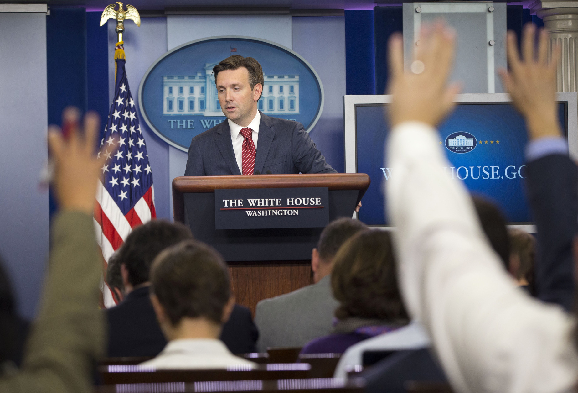 Journalist raises their hands as White House Press secretary Josh Earnest speaks to the media during the daily briefing in the Brady Press Briefing Room of the White House in Washington, Thursday, Oct. 1, 2015. Earnest responded to a report of multiple shootings at Umpqua Community College in central Oregon. (AP Photo/Pablo Martinez Monsivais)