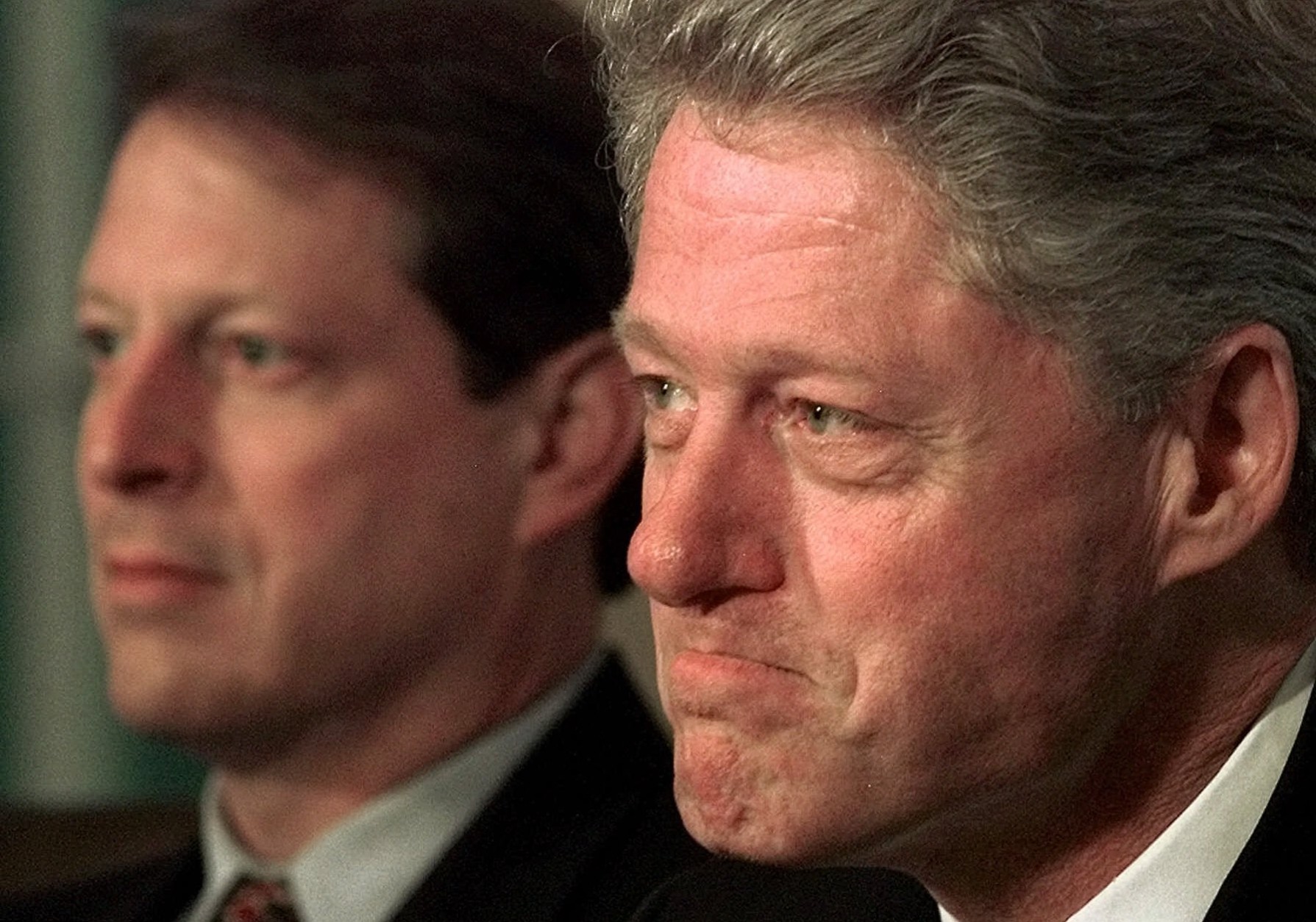 A tight-lipped President Clinton listens to questions from reporters about the Congressional vote to proceed with an impeachment inquiry against him during a meeting with his economic team at the White House Thursday Oct. 8, 1998. At left is Vice President Al Gore. (AP Photo/Greg Gibson)