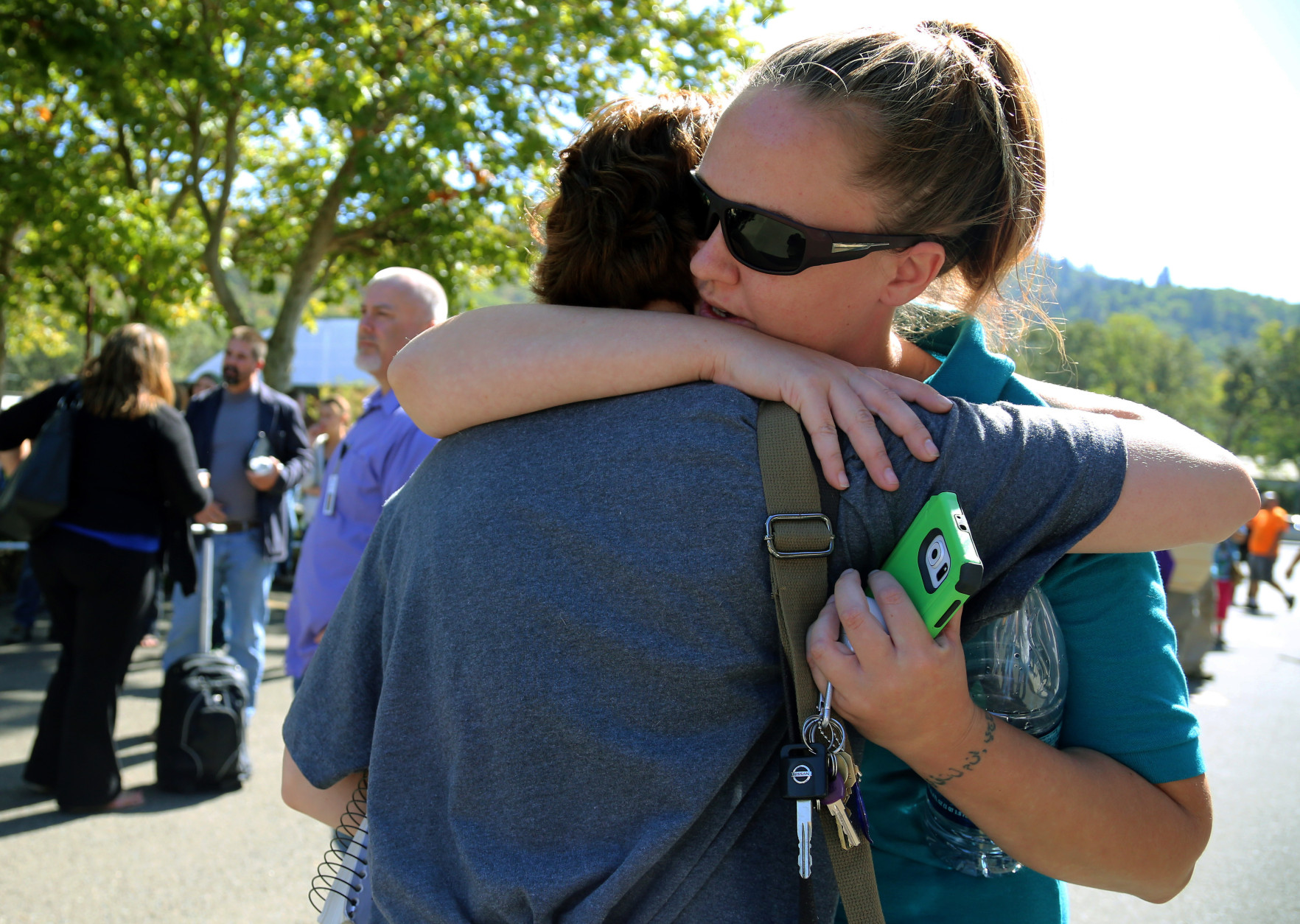 A woman is comforted as friends and family wait for students at the local fairgrounds after a shooting at Umpqua Community College in Roseburg, Ore., on Thursday, Oct. 1, 2015.   (AP Photo/Ryan Kang)
